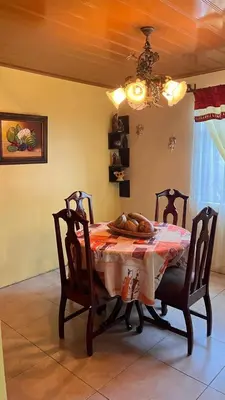 a dining room with a table and two chairs at Casa morfo in Bijagua