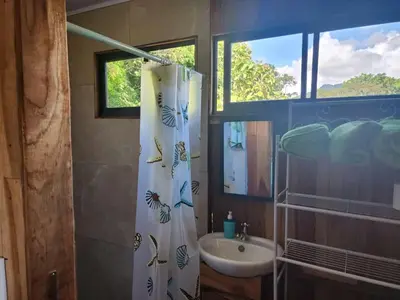 a bathroom with a sink and a shower curtain at Paso-lapas in Matapalo