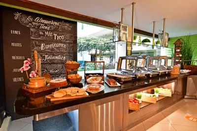 a bakery with a buffet of food on a counter at Auténtico Hotel in San José