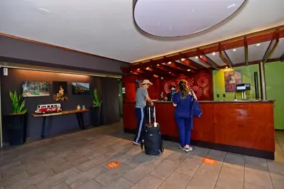 a man and a woman standing at a bar at Auténtico Hotel in San José
