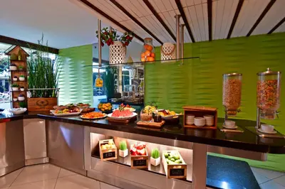 a buffet line with food on display in a restaurant at Auténtico Hotel in San José