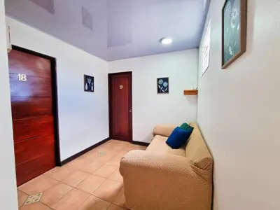 a living room with a couch and a door at Sabana Studios in San José
