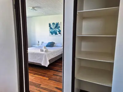 a bedroom with a bed and a book shelf at Sabana Studios in San José