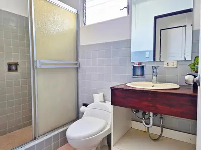 a bathroom with a toilet and a sink at Sabana Studios in San José