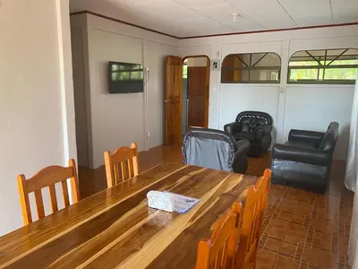 a living room with a wooden table and chairs at Casas La Chirincoca in San Isidro