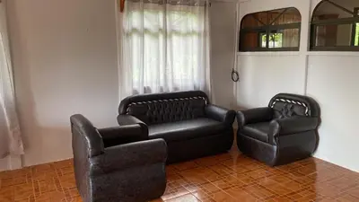 a living room with a couch and a chair at Casas La Chirincoca in San Isidro