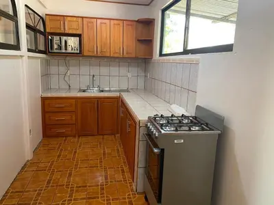 a small kitchen with a stove and a sink at Casas La Chirincoca in San Isidro