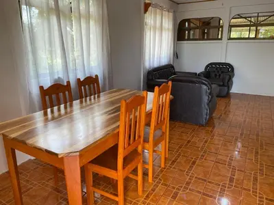 a living room with a wooden table and chairs at Casas La Chirincoca in San Isidro