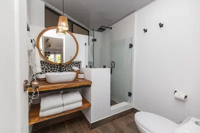 a bathroom with a sink and a mirror at ECOTICA Boutique Hotel & Spa in Manuel Antonio