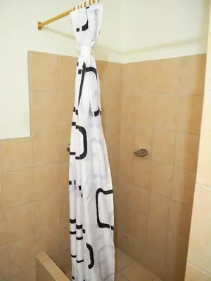 a black and white dress hanging in a shower at Nuevo Maragato Hotel & Hostel in San José