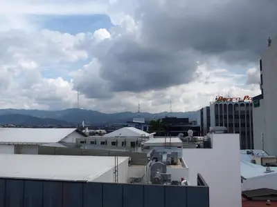 a view of a city with buildings and clouds at Nuevo Maragato Hotel & Hostel in San José