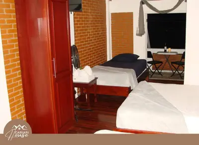 a room with two beds and a room with a table at Full house, 11BR, 12BA, 10 min from SJO Airport in Heredia