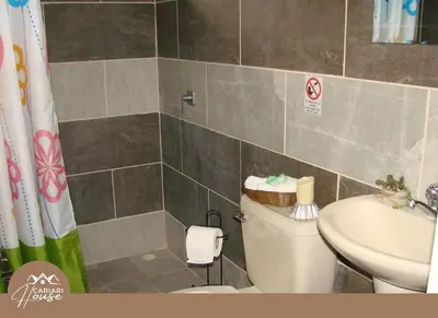 a bathroom with a toilet and a sink at Full house, 11BR, 12BA, 10 min from SJO Airport in Heredia