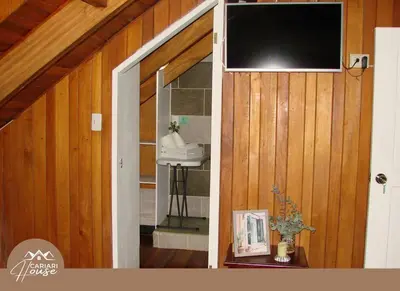 a room with a television on a wooden wall at Full house, 11BR, 12BA, 10 min from SJO Airport in Heredia
