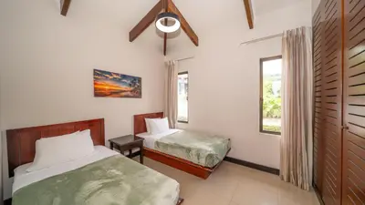 a bedroom with two beds and a window at MonteMar Beach Condo At Playa hermosa in Sardinal