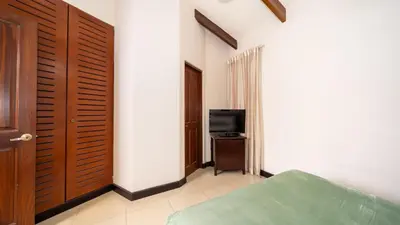 a bedroom with a bed and a television in it at MonteMar Beach Condo At Playa hermosa in Sardinal