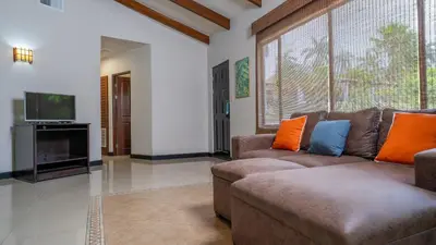 a living room with a couch and a tv at MonteMar Beach Condo At Playa hermosa in Sardinal