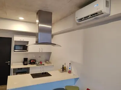 a kitchen with a sink and a stove top oven at 804 SECRT Sabana Hermoso Apartamento con Aire Acondicionado in San José