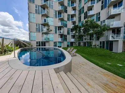 a swimming pool in front of a building at 804 SECRT Sabana Hermoso Apartamento con Aire Acondicionado in San José