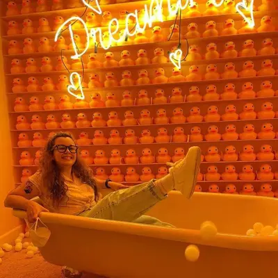 a woman sitting in a bath tub with her feet up at 804 SECRT Sabana Hermoso Apartamento con Aire Acondicionado in San José