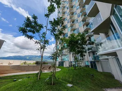 a large apartment building with trees in front of it at 804 SECRT Sabana Hermoso Apartamento con Aire Acondicionado in San José