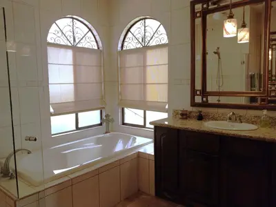 a bathroom with a tub and a sink and a mirror at Casa Sol Azul - remarkable, ocean view 4 BR House in Potrero in Potrero