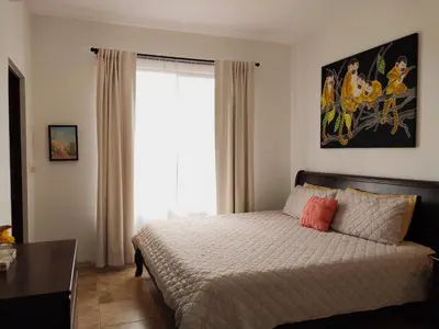 a bedroom with a bed with a large window at Casa Sol Azul - remarkable, ocean view 4 BR House in Potrero in Potrero