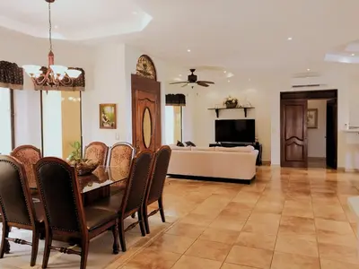 a living room with a dining table and a couch at Casa Sol Azul - remarkable, ocean view 4 BR House in Potrero in Potrero