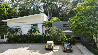 two cars parked in front of a white house at Condo Casa Blanca 6 - modern 2BR,2BA near to Beach & Town in Potrero