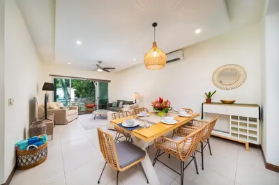 a dining room and living room with a table and chairs at Condo Casa Blanca 6 - modern 2BR,2BA near to Beach & Town in Potrero