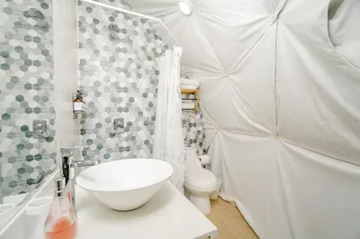 a white bathroom with a shower and a toilet at Glamping Tortuga Verde in Ocotal