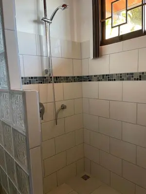 a bathroom with a shower with a window at Villa Del Mar 2 Spectacular ocean view! in Dominical