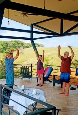 a group of people with their hands in the air at VILLA SIMONE ARENAL French Ecolodge in Tilarán
