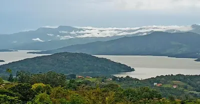 a view of a large body of water with mountains at VILLA SIMONE ARENAL French Ecolodge in Tilarán