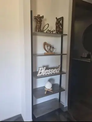 a shelf with some items on it in a room at Casa Bella in Jacó