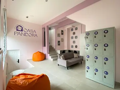 a room with a couch and a chair in a room at Casa Pandora Hostel Women Only in San José