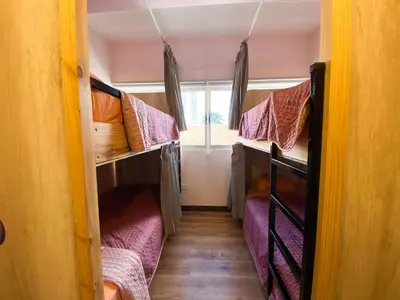 a room with two bunk beds in a house at Casa Pandora Hostel Women Only in San José