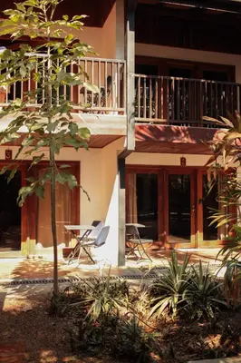 a building with chairs and a table in front of it at Chocolate in Tamarindo
