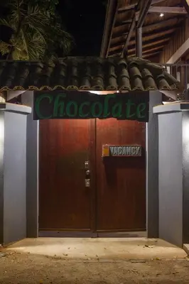 a large wooden door with a sign on it at Chocolate in Tamarindo