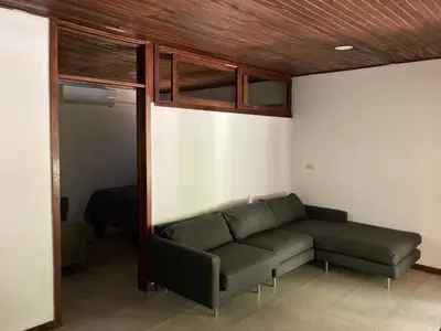 a living room with a couch and a bed at Chocolate in Tamarindo