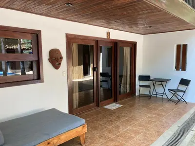 a room with a bed and a table and chairs at Chocolate in Tamarindo