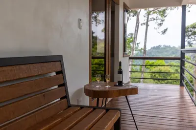 a balcony with a table with two glasses of wine at Casa Kabuae in Portalón
