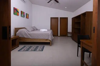 a bedroom with a bed and a table and a desk at Casa Kabuae in Portalón