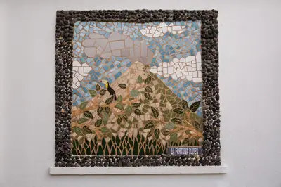 a mosaic picture of a bird on a mountain at La Fortuna Lodge by Treebu Hotels in Fortuna