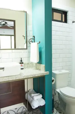 a bathroom with a sink and a toilet at La Fortuna Lodge by Treebu Hotels in Fortuna