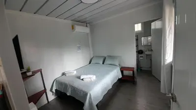 a bedroom with a bed with two towels on it at Apartamentos Equipados DMR #3 in Uvita