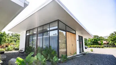 a house with large glass doors on the side of it at Villa Tanager in Fortuna