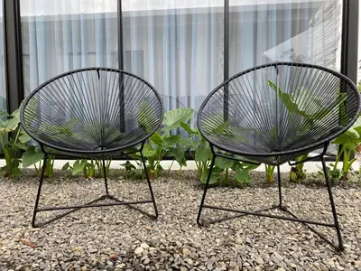 two chairs sitting next to each other in a garden at Villa Tanager in Fortuna