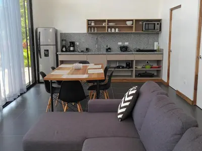 a living room with a couch and a table at Villa Tanager in Fortuna