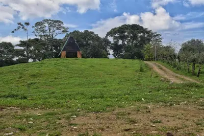 a grassy hill with a pyramid on top of it at Quinta Túru in Colonia